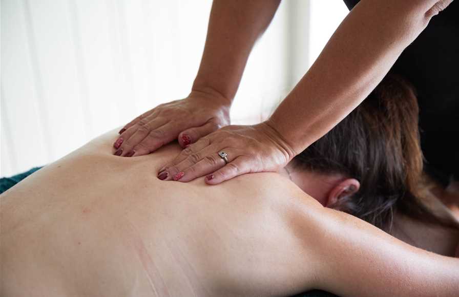 Our complementary therapist giving a back massage.