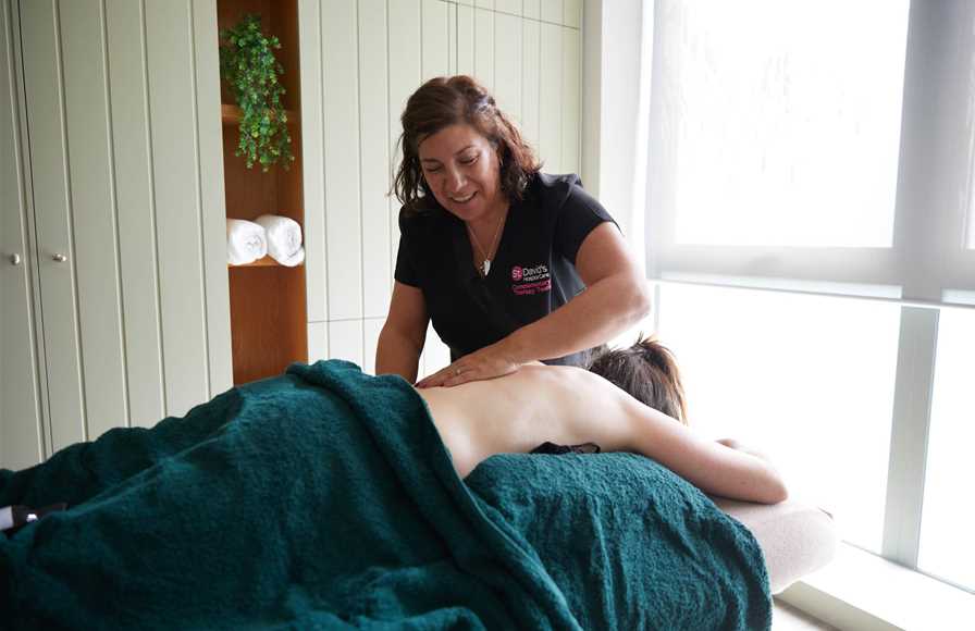 Our complementary therapist giving a back massage.